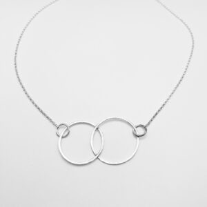 Two interconnecting circular hoops made from recycled sterling silver on a silver trace chain.