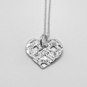 Handmade textured heart pendant made from recycled sterling silver on a trace chain.